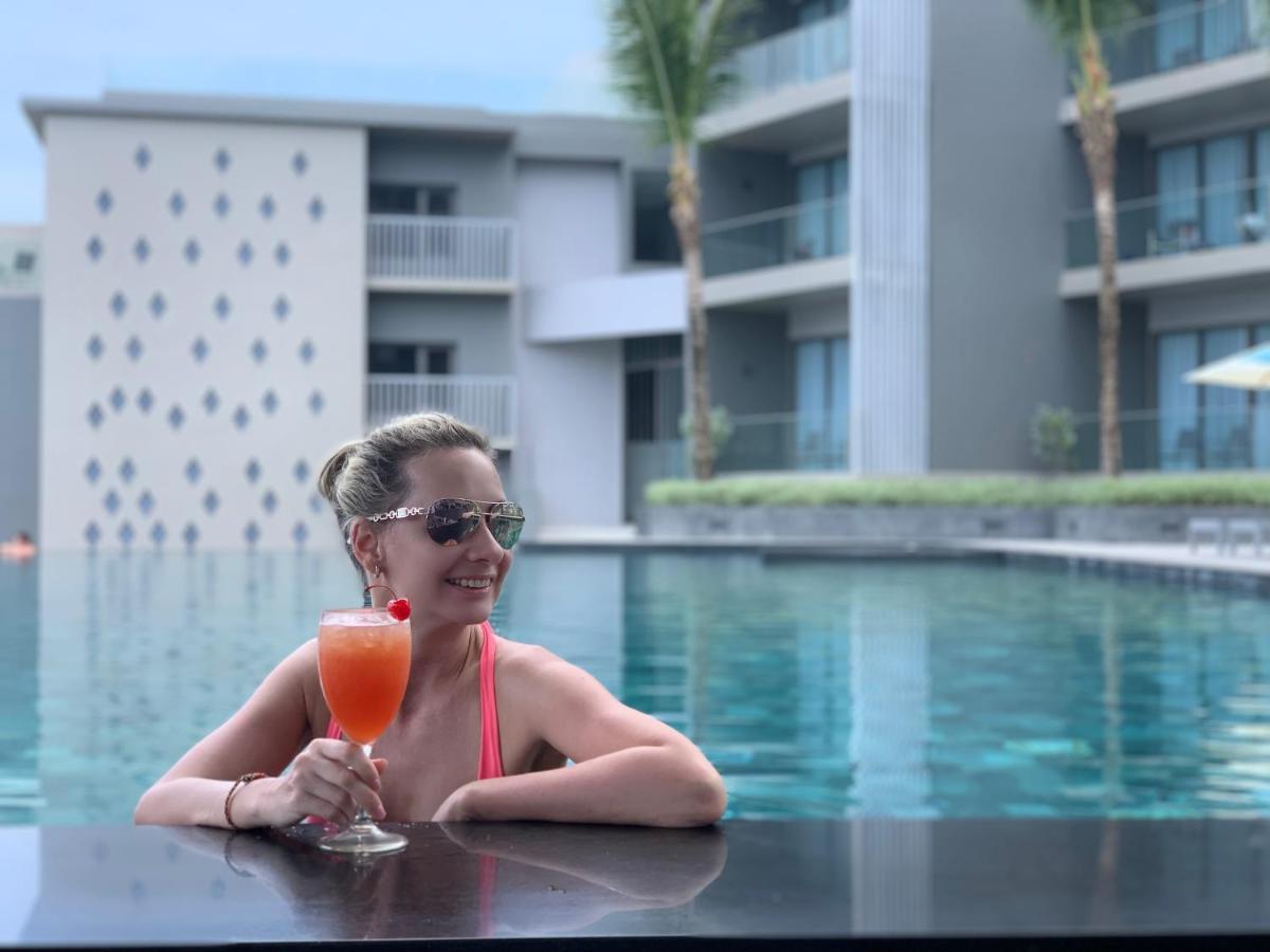 Oceanfront Beach Resort - Sha Extra Plus Patong Extérieur photo A woman at a pool in Phuket, Thailand